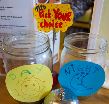 Two tip jars with opposite labels hoping you vote for one or the other