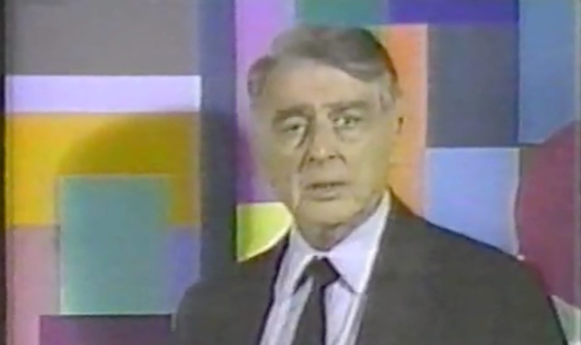 Screen Capture of Edwin Land standing infront of a color background
