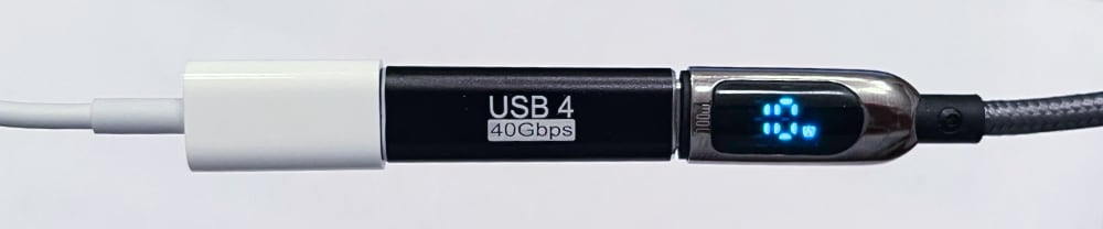 USB-C Cable plugged into an adapter, which is plugged into another USB-C cable with a small LED screen showing the current power draw of 10W