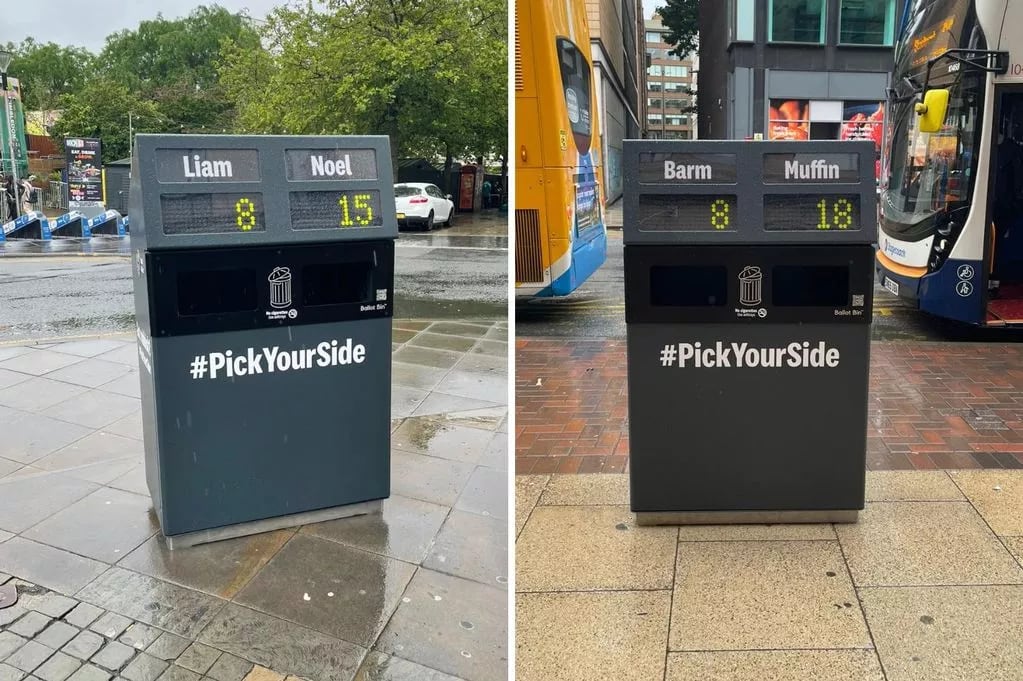 Street Trashcans with two holes and a label and counter. The idea is you vote for which concept you prefer by adding more trash.