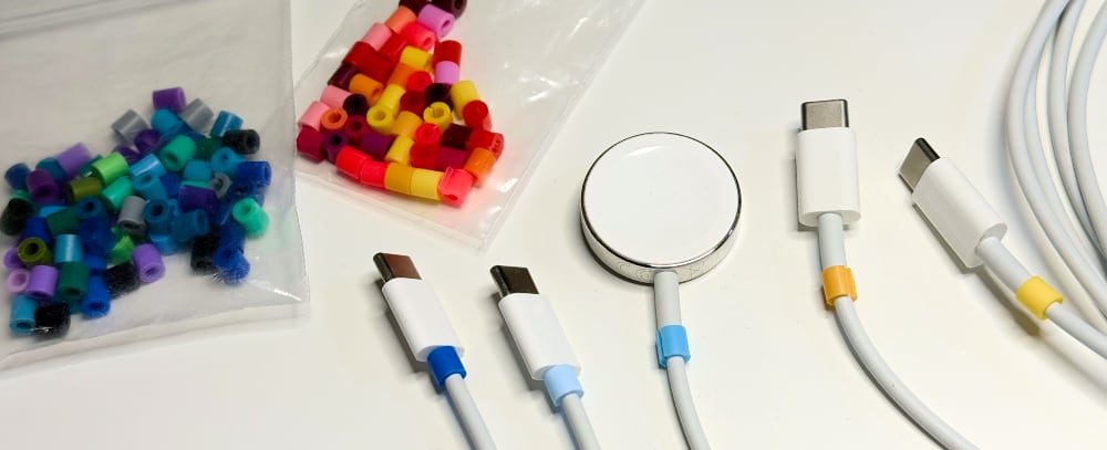 Photo of several cables with bead labels and two bags full of extra beads sorted by warm and cool colors.